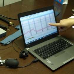 Client booking a polygraph test on phone in India
